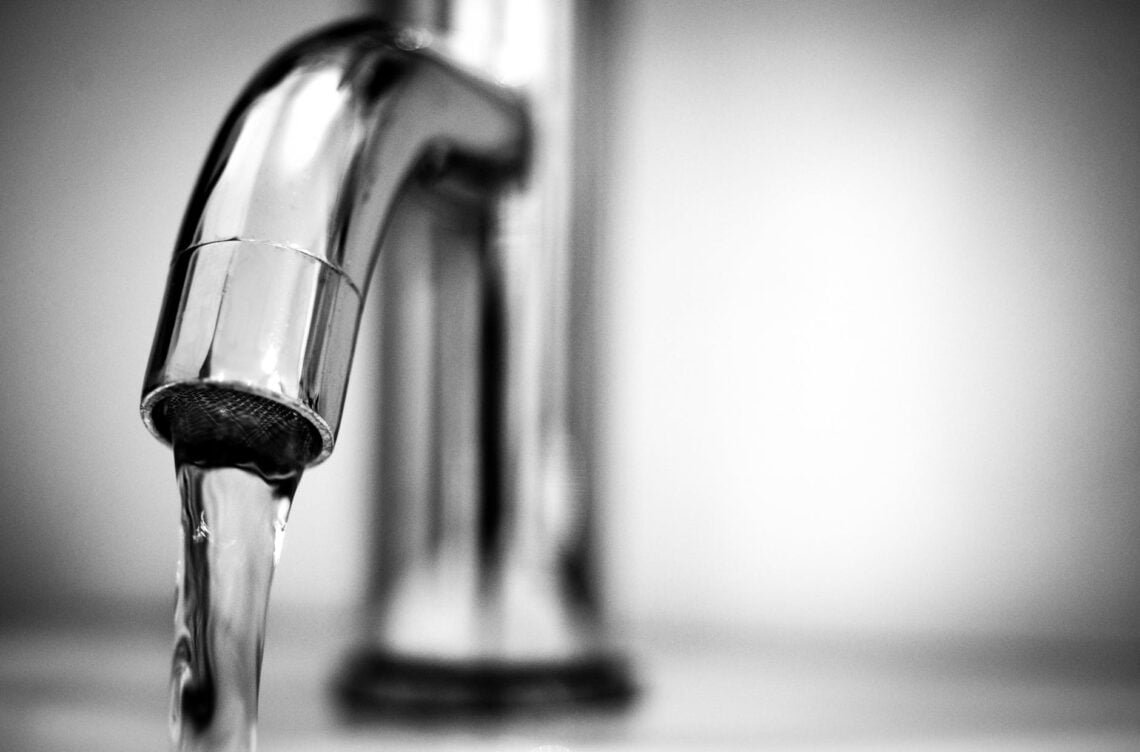 macro photography of a stainless steel faucet