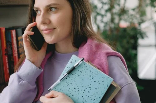 woman holding black smartphone