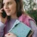 woman holding black smartphone