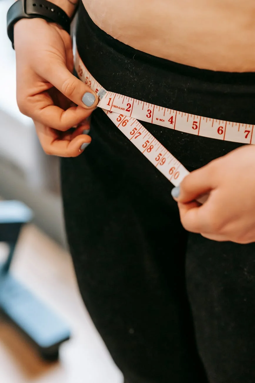 plus size woman measuring hips in gym